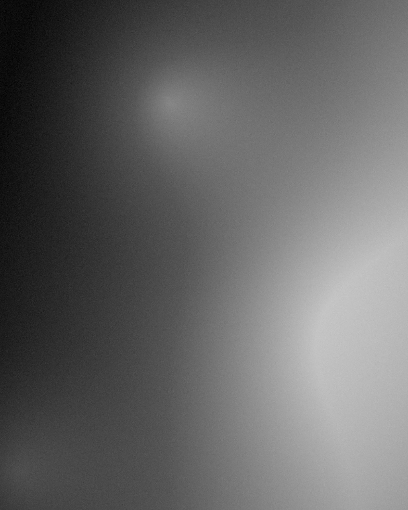 Two people talking in a dim corner